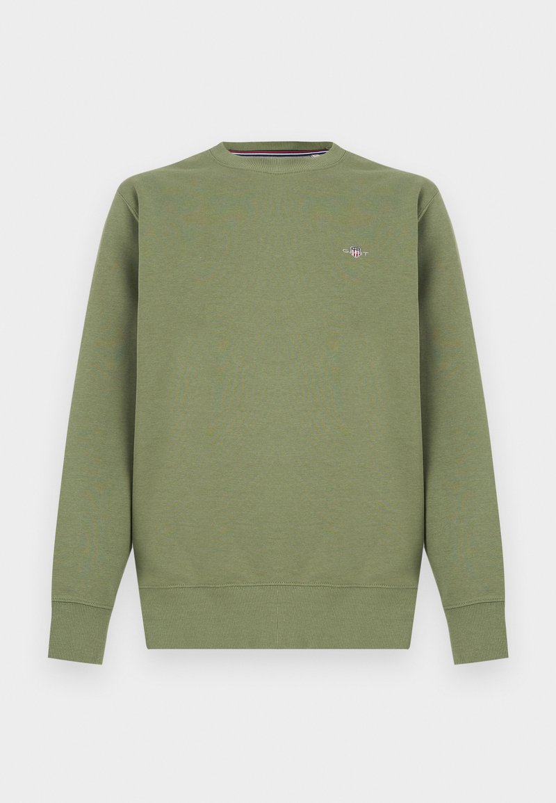 Sweatshirt vert en mélange de coton avec col rond, poignets et ourlet côtelés. Présente un petit logo sur la poitrine. Texture lisse.