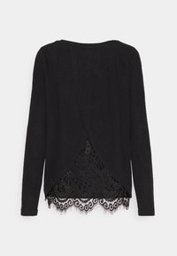 Haut noir à manches longues avec un ourlet en dentelle présentant des motifs floraux et des bords festonnés, design dos drapé, texture de tissu douce.