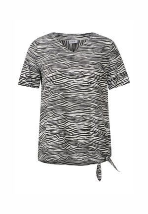 Chemise à manches courtes rayée noir et blanc avec un col en V et un détail de nœud à l'ourlet, fabriquée en tissu léger et doux.
