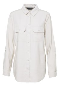 Camisa de manga larga color beige claro con cuello, dos bolsillos en el pecho, cierre de botones y tabulaciones para enrollar las mangas. Fabricada en un tejido suave.