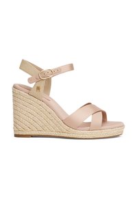 Wedge sandals featuring a beige synthetic upper and woven jute heel. Adjustable ankle strap with a gold buckle detail. Crossed front straps.