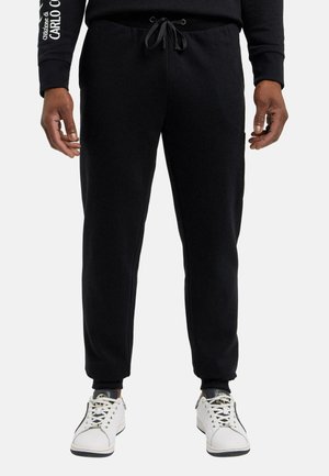 Sorte sweatpants med snoretræk i taljen, ribbede cuffs og sidelommer. Fremstillet af blødt stof, der har en glat tekstur.