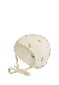 Cream baby bonnet with small brown teddy bear faces and adjustable tie straps beneath the chin.