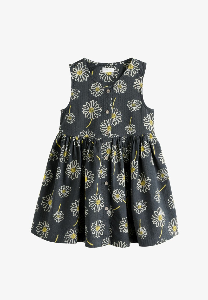 Ujjatlan fekete kisgyermek ruha elején gombokkal és fehér margaréta virágmintával, sárga középpel és szárakkal.