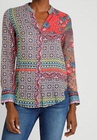 Multicolored button-up shirt featuring intricate floral and geometric patterns, long sleeves, a collar, and a lightweight, sheer fabric.