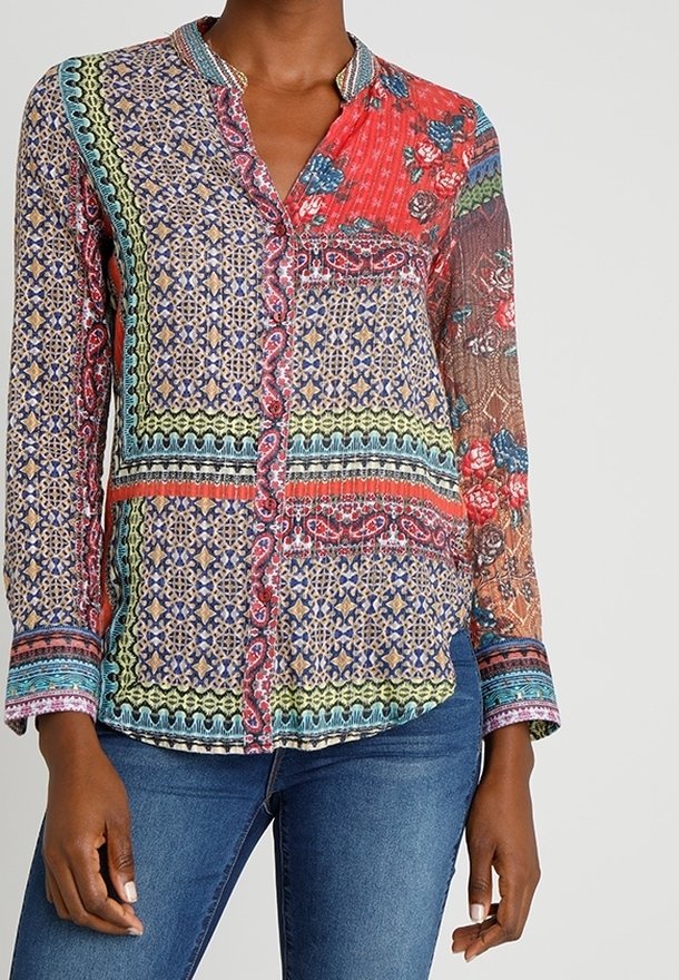 Multicolored button-up shirt featuring intricate floral and geometric patterns, long sleeves, a collar, and a lightweight, sheer fabric.