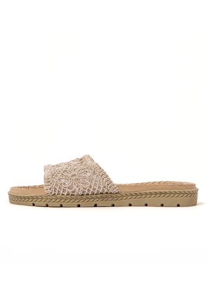 Open-toe sandal with a textured beige embroidered upper, flat light brown sole, and a subtle braided pattern along the edge.
