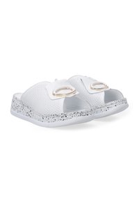 Witte slide-sandalen met een geperforeerde bovenkant, open teenontwerp en gouden hardwareaccenten op de banden. Getextureerde gespikkelde zool.