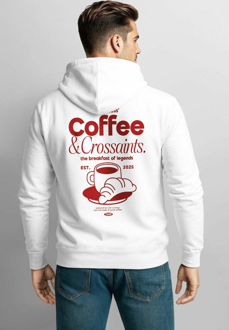 White hoodie featuring red text that reads "Coffee & Croissants." with graphic of a cup and croissant. Simple design and soft fabric.