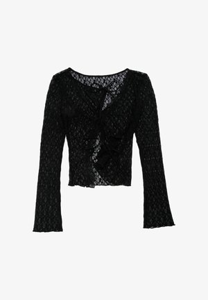 Black lace long-sleeve top with a v-neck, front ties, and flared sleeves. Features a scalloped hem and an intricate floral pattern.