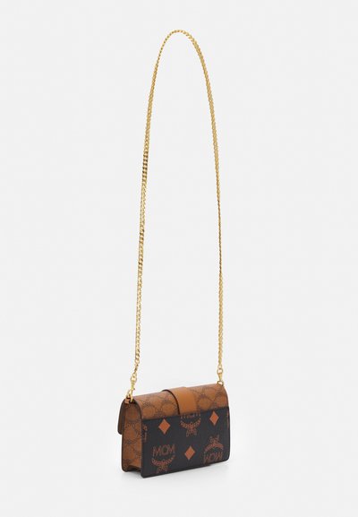 Brown and black leather crossbody bag with a gold chain strap, featuring a logo pattern and diamond accents, rectangular shape, and smooth texture.