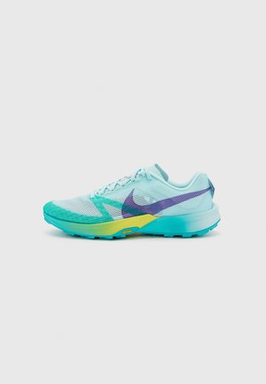 Nike running shoe featuring a light blue mesh upper, purple swoosh, and turquoise sole with a textured pattern for grip.
