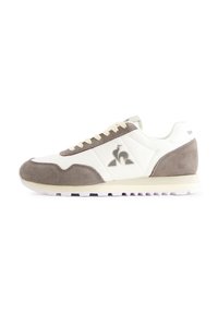 White and gray sneakers made of suede and synthetic materials, featuring a round toe, contrasting laces, and a logo on the side.