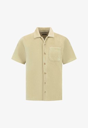 Beige kurzärmliges Shirt aus geripptem Stoff. Verfügt über einen Kragen, Frontknöpfe und eine aufgesetzte Tasche auf der linken Brust.