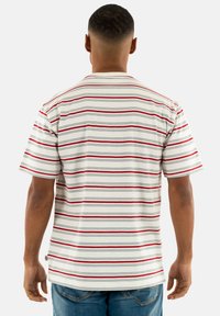 Striped short-sleeve shirt in white with red, navy, and gray horizontal lines. Round neckline and loose fit, made from soft cotton material.