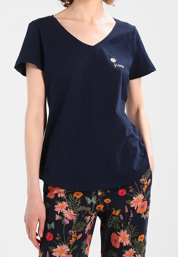 Námořnická modrá bavlněná trička s výstřihem do V a krátkými rukávy, která má malý vyšitý design listu a volný střih.