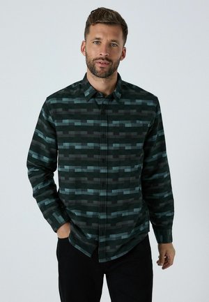 Grøn- og sortternet skjorte med knapper og afslappet pasform, der har varierende rektangulære mønstre og en brystlomme.