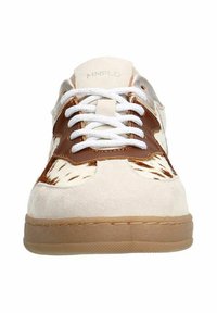 Sneakers feature a cream suede upper, brown leather accents, white laces, and a rubber sole with a textured pattern.