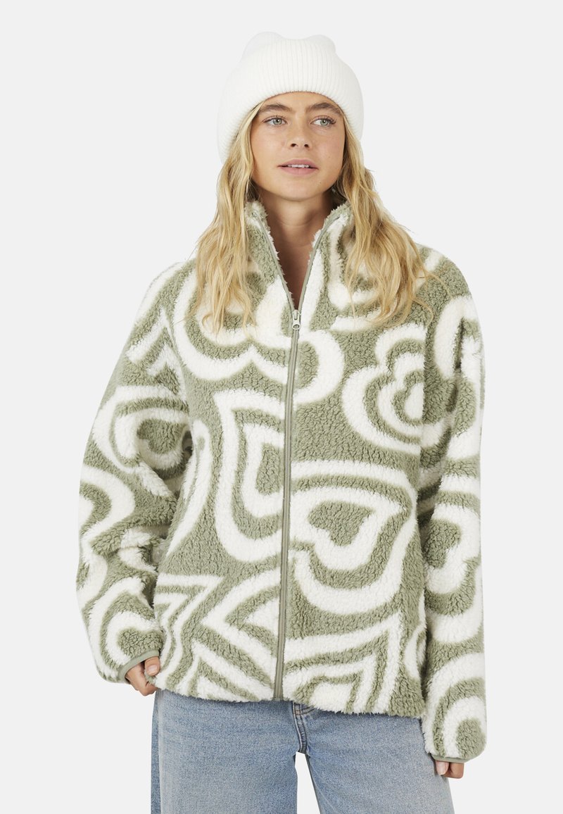 Groene fleece ritsjack met wit abstract draaipatron. Heeft een hoge kraag en elastische manchetten, een zachte textuur en een relaxed pasvorm.