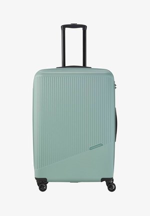 Valise rigide de couleur vert menthe clair, avec des rainures verticales, une poignée noire télescopique et des roues à 360 degrés pour une maniabilité aisée.