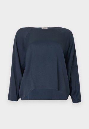 Marineblaue Langarmbluse mit lockerem Schnitt, rundem Ausschnitt und leicht geschwungenem Saum. Hergestellt aus glattem, leichtem Stoff.