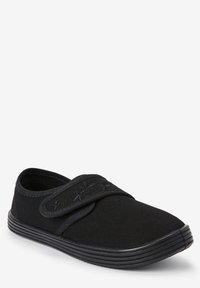 Chaussure slip-on en toile noire avec un bout arrondi, dotée d'une sangle velcro et d'une semelle en caoutchouc texturé pour une meilleure adhérence. Design simple et fonctionnel.