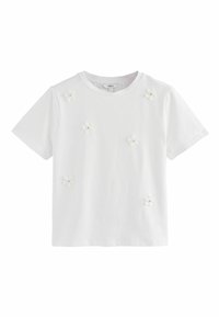 Hvid bomulds T-shirt med korte ærmer, prydet med små 3D blomsterapplikationer i hvid og lysegrøn, spredt over forsiden.