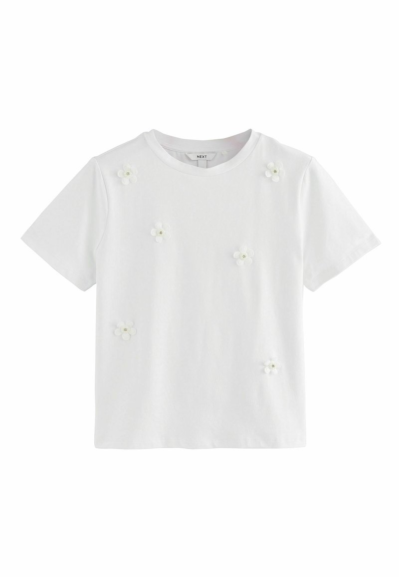 Hvid bomulds T-shirt med korte ærmer, prydet med små 3D blomsterapplikationer i hvid og lysegrøn, spredt over forsiden.