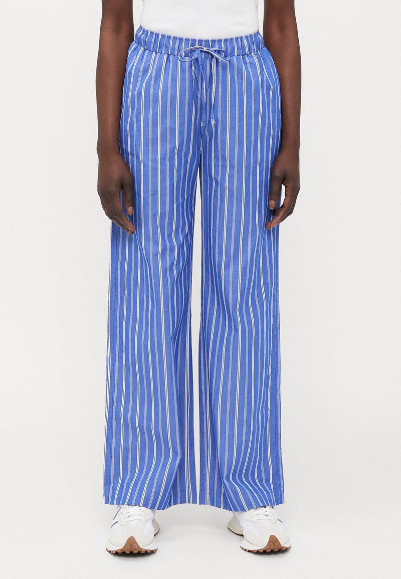 Blue and white striped wide-leg pants with an elastic waistband and drawstring. Made of lightweight fabric, featuring a relaxed fit.