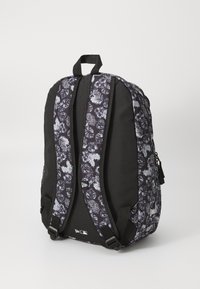 Black backpack featuring a floral pattern in dark blue and white, with padded shoulder straps and side pockets for extra storage.
