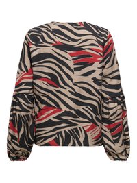 Blusa de manga larga con rayas abstractas de cebra en beige, negro y rojo y puños fruncidos.