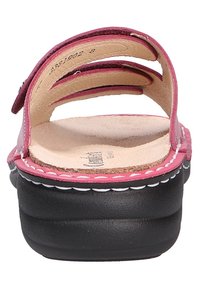 Pink leather sandals with three straps, a natural leather insole, and a black platform sole featuring white stitching details.
