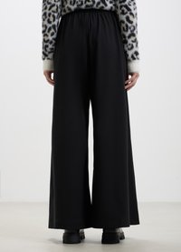 Calliope TINTA UNITA - Pantaloni - nero