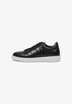 Black low-top sneaker with croc-textured leather upper and white rubber sole, shown in side profile view against white background.