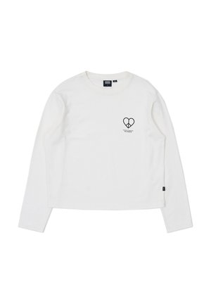 Crewneck long-sleeve T-shirt in off-white cotton. Features a small black heart graphic on the chest and a black label on the side.