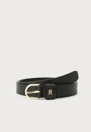 Black leather belt with gold-tone rounded buckle and small embossed logo on the loop, resting coiled on a white background.