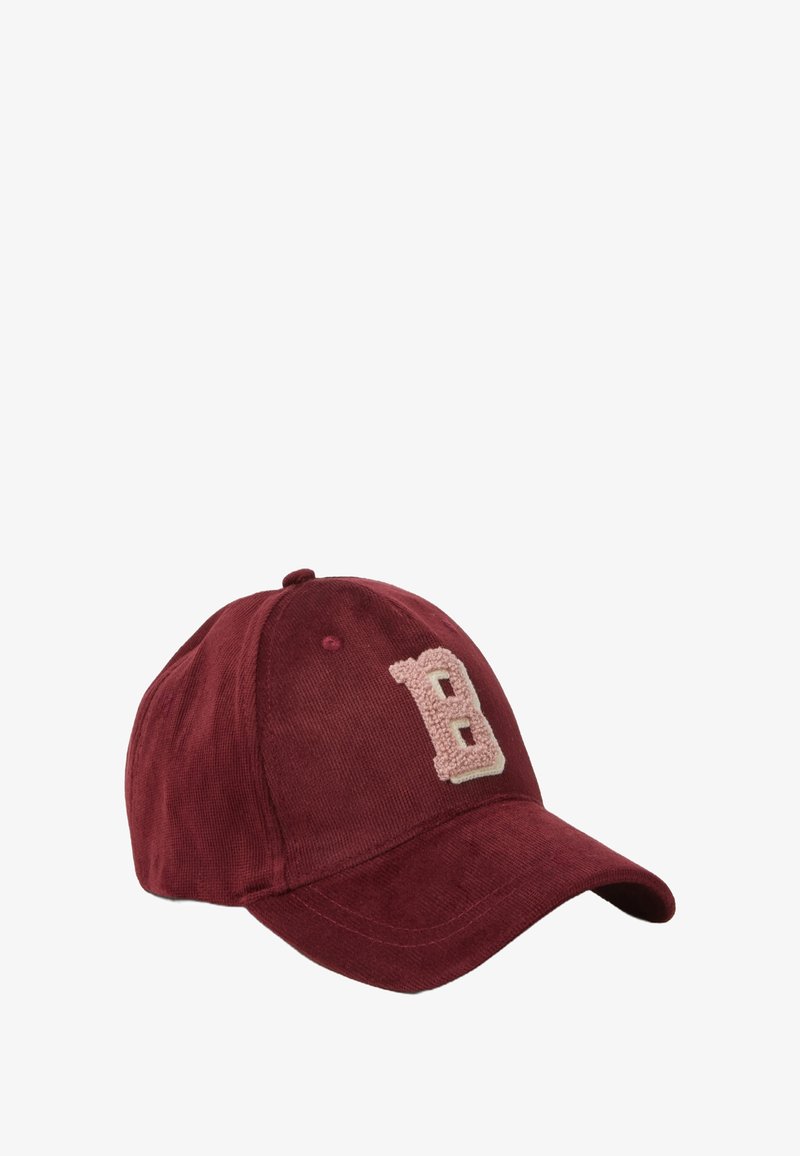 Cappello da baseball in velluto a coste color marrone scuro con un emblema "B" morbido e testurizzato di colore rosa chiaro sul davanti. Presenta una visiera curva e una fascia posteriore regolabile.