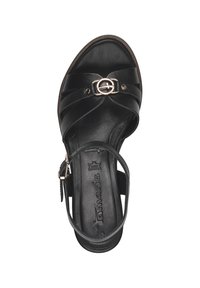Black heeled sandal with a textured leather upper, featuring crisscross straps and a central decorative buckle. Smooth inner lining.