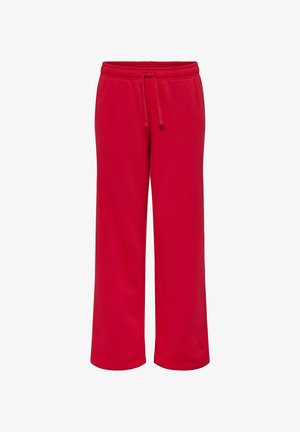 Czerwone dresy wykonane z miękkiego materiału, z elastycznym pasem ze sznurkiem, luźnymi nogawkami i bez widocznych wzorów czy elementów metalowych.