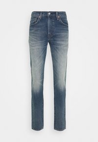 Jeans denimowe w odcieniu od ciemnoniebieskiego do jasnoniebieskiego w gradientowym przejściu. Prosty krój nogawki, pięć kieszeni, metalowe nity i zapięcie na guzik.
