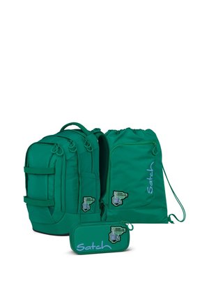 Green backpack, drawstring bag, and pencil case with "Satch" branding and "Trash makes the difference" patches.