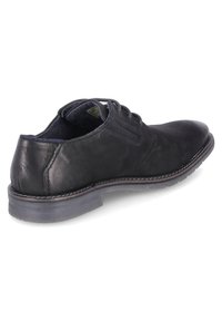 Scarpa da uomo in pelle nera con lacci, tacco basso, dettaglio con zip laterale e suola cucita.
