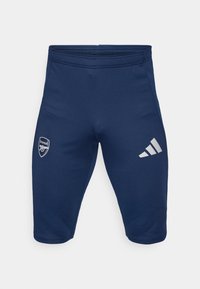 Navy athletic shorts made of stretchy fabric, featuring an Arsenal logo on the left leg and three white Adidas stripes on the right leg.