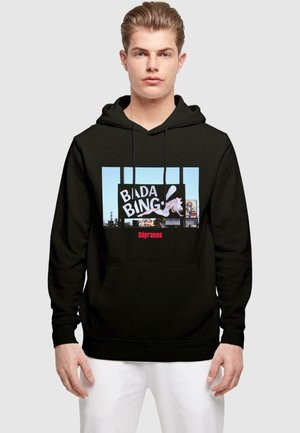 Black hoodie featuring a graphic with "BADA BING" in bold white letters and "sopranos" in red, set against a blue background.