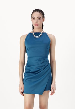 Teal satin dress with a halter neckline and gathered details. Features a draped effect on the front, knee-length cut, and smooth texture.