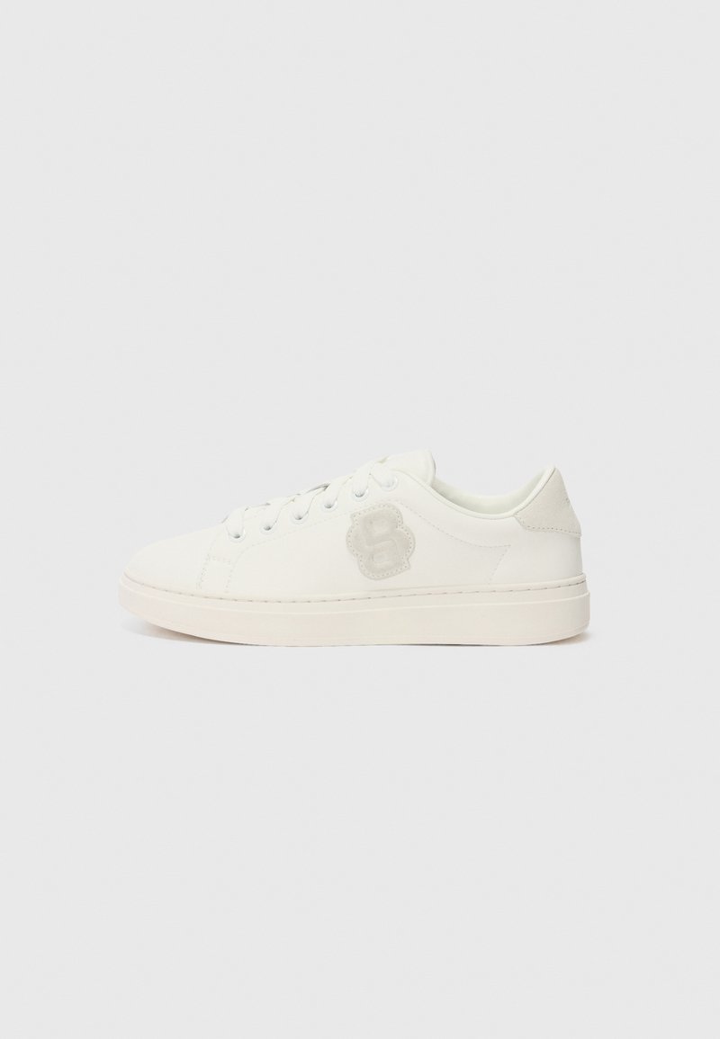 Sneaker bianco con tomaia in pelle liscia, punta rotonda, lacci piatti e una patch con logo testurizzato sul lato. Suola in gomma con minimo battistrada.