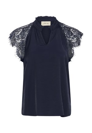 Navy-blaues Hemd mit Spitzen-Kapellärmeln, das einen rüschierten Mock-Neck-Kragen und einen Ausschnitt in Form eines Schlüssellochs auf der Vorderseite hat. Glatte Stoffstruktur.