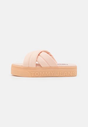 Jasnopomarańczowy sandał wsuwany z grubymi, krzyżującymi się materiałowymi paskami i masywną podeszwą z tłoczonym logo "TOMMY JEANS".