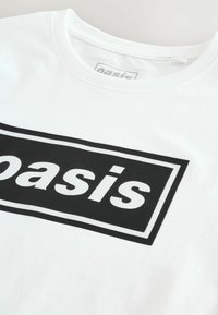 Witte katoenen t-shirt met een grote zwarte rechthoekige grafiek waarop het woord "oasis" in vetgedrukte letters staat. Crew neck ontwerp.