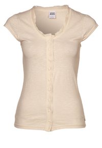 Beige kortärmad skjorta med rund halsringning, med en volangkant och en rad knappar fram. Mjuk, lätt tyg.